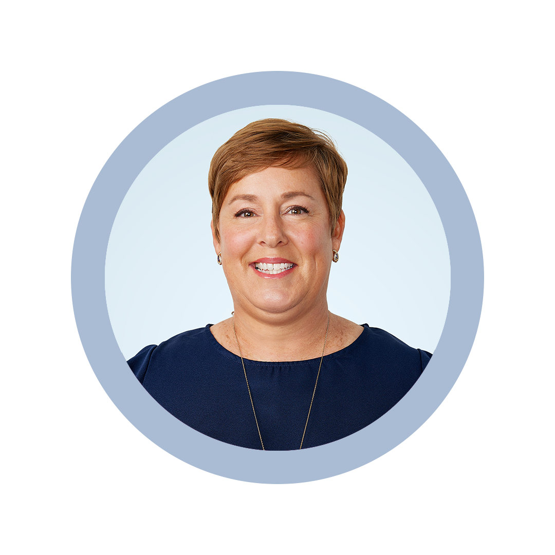 Sandy Noble headshot against light blue background