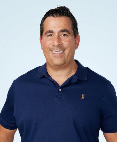 Fred Elabed headshot against light blue background