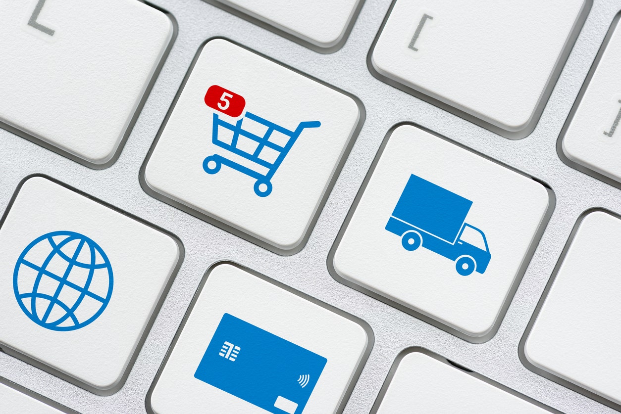 Laptop buttons depicting a shopping cart, shipping truck, the internet, and a credit card