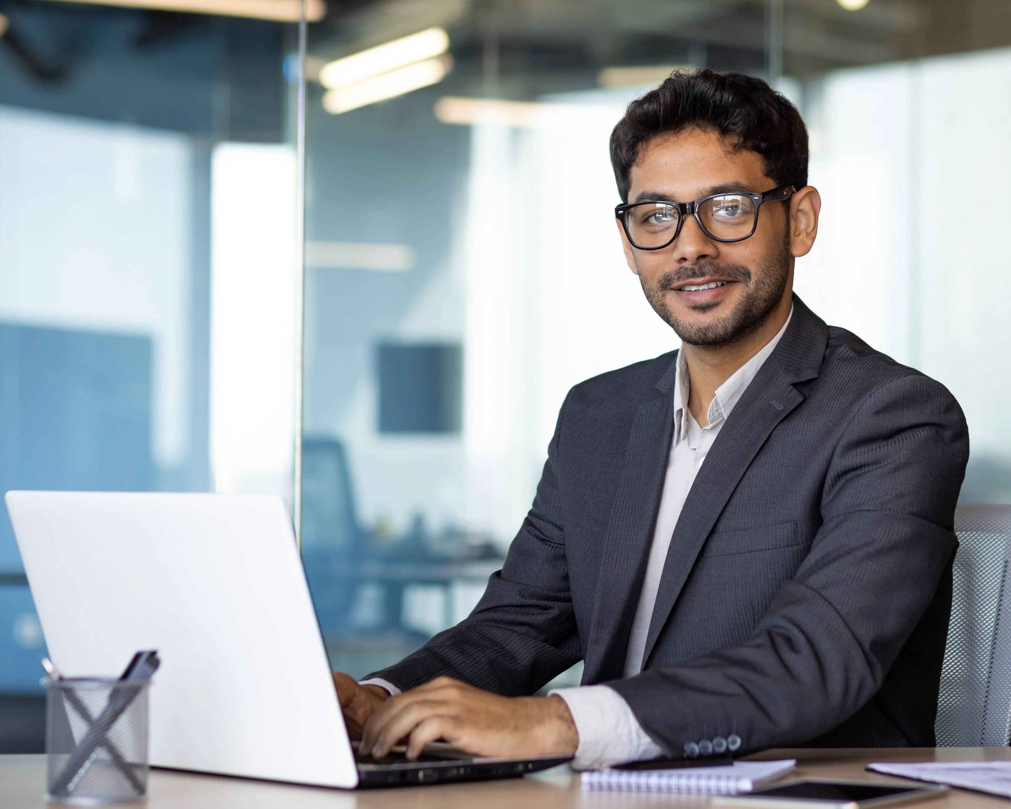 Man typing on laptop in an office
